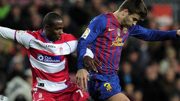 Odion Ighalo challenges Barcelona's Gerard Pique