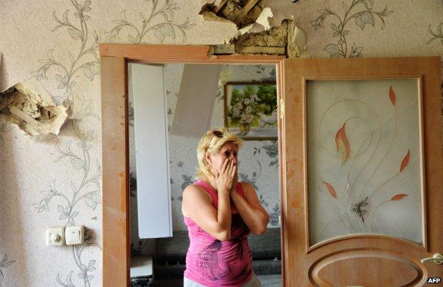 A woman cries in her damaged house in the eastern Donetsk region - 30 July 2014