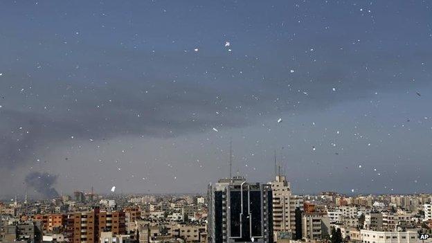 An Israeli plane drops leaflets to warn residents, 30 July