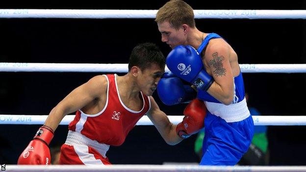 Wales' Ashley Williams (right) guaranteed himself a medal after beating Malaysia's Muhamad Fuad Mohd Redzuan in the men's light-flyweight quarter-final