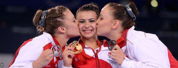 England's Claudia Fragapane (centre) is kissed by compatriots Ruby Harrold (left) and Hannah Whelan (right).