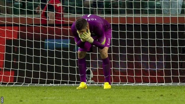 Celtic keeper Fraser Forster stands dejected as Leiga Warsaw score their fourth goal of the game.