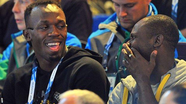 Bolt jokes with a friend at the netball