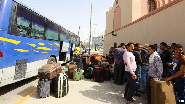 Egyptian workers prepare to board a bus in Tripoli as they are evacuated from Libya (31 July 2014)