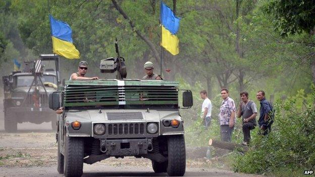 Ukrainian servicemen patrol in vehicles near eastern Ukraine