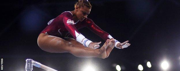 Beckie Downie swings over the uneven bars at the Commonwealth Games.