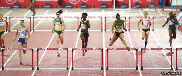 Kaliese Spencer of Jamaica (3R) clears the final hurdle ahead of Eilidh Child of Scotland (2L)