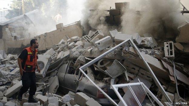 A car under the wreckage of a building