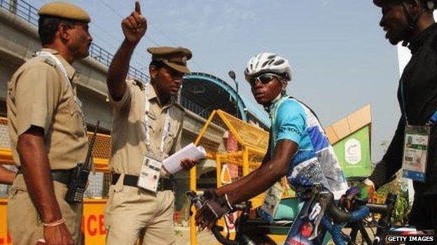 Cyclists Sesay Moses Lansana and Seisay Augustine of Sierra Leone (right) talk to security officials at the athletes village ahead of the 2010 Commonwealth Games in Delhi