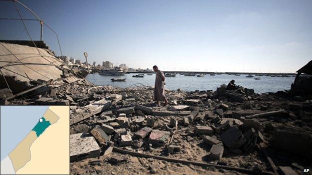 A Palestinian man inspects the damage of a police post, following an Israeli missile strike killing four boys from the same extended Bakr family, in Gaza City, Wednesday, July 16, 2014