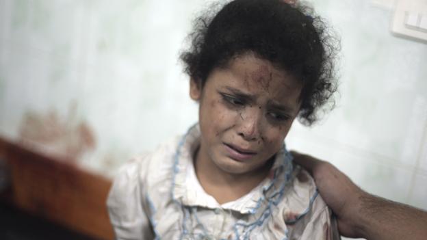 A girl cries after the school in which she was sheltering in Jabaliya was shelled, 30 July