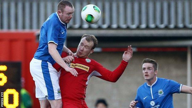 Kyle McVey beats Liam Boyce to the high ball while playing for Linfield