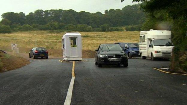 Cars passing the Kelston toll road kiosk