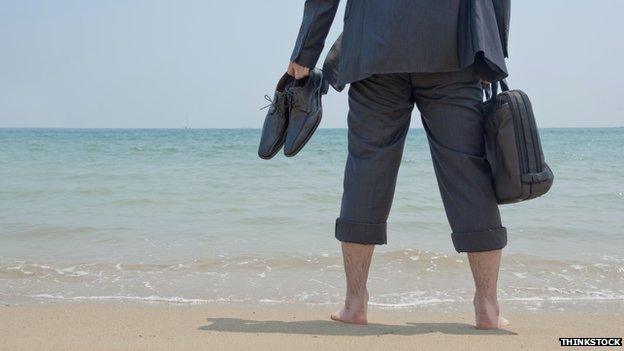 Businessman paddling on a beach