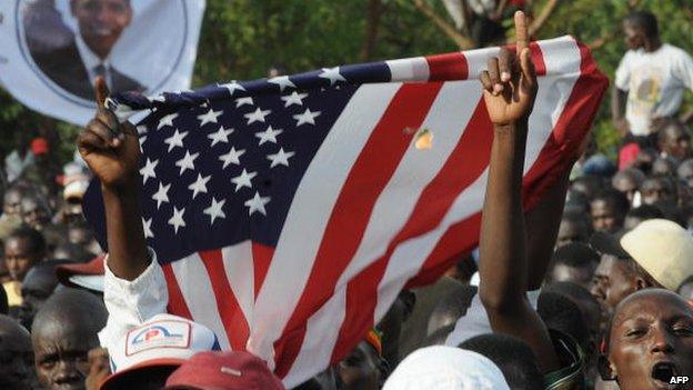 Kenyans holds up the US flag as they celebrate after the inauguration of US president Barack Obama's on 20 January 2009 in Kisumu, Kenya