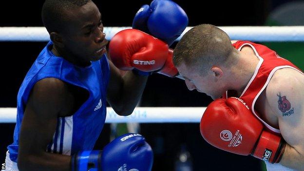 Northern Ireland's Paddy Barnes (red) in action against Uganda"s Fazil Juma Kaggwa