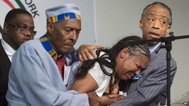 Esaw Garner, center, wife of Eric Garner, breaks down in the arms of Rev Herbert Daughtry and Rev Al Sharpton