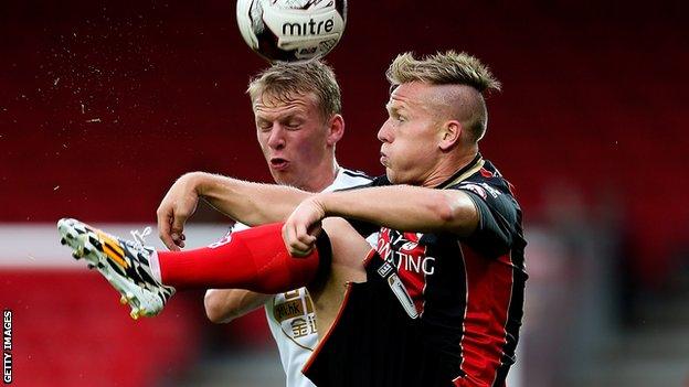 Matt Ritchie of Bournemouth holds off pressure from Stephen Kingsley of Swansea