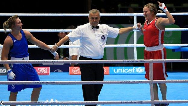 Canada's Ariane Fortin (red) celebrates her win against Wales's Lauren Price in the women's middleweight semi-finals