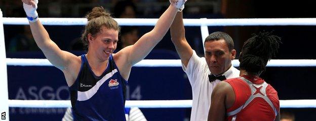 Savannah Marshall (blue) celebrates her win against Nigeria"s Edith Ogoke