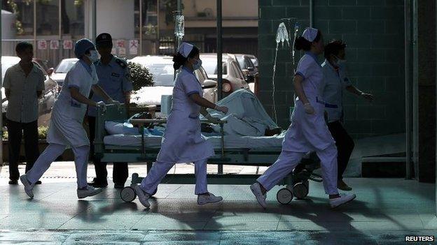A victim is rushed to hospital in Kunshan, 2 Aug