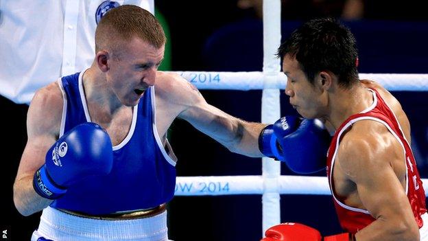 Paddy Barnes lands a left hand on India's Devendro Laishram