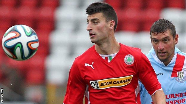 Johnny Flynn of Cliftonville in action against Ballymena United's Matthew Tipton