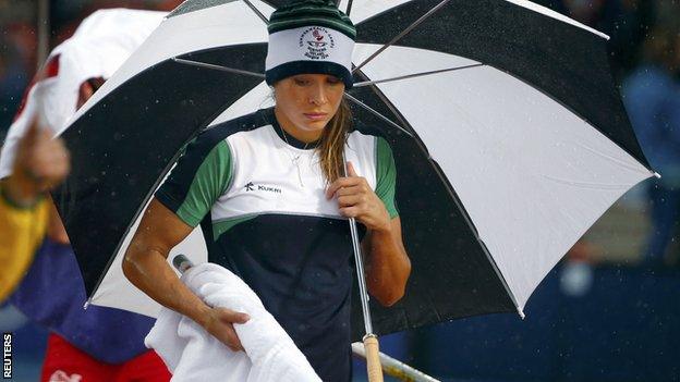 Zoe Brown shelters from the rain at Hampden Park