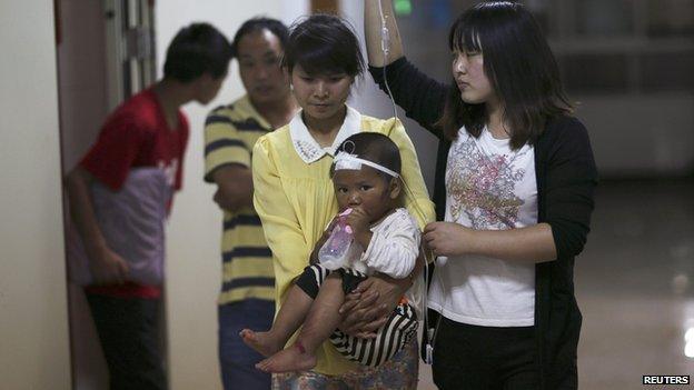 A child drinks milk from a bottle at a hospital after being injured in an earthquake in Ludian county of Zhaotong, Yunnan province August 3, 2014