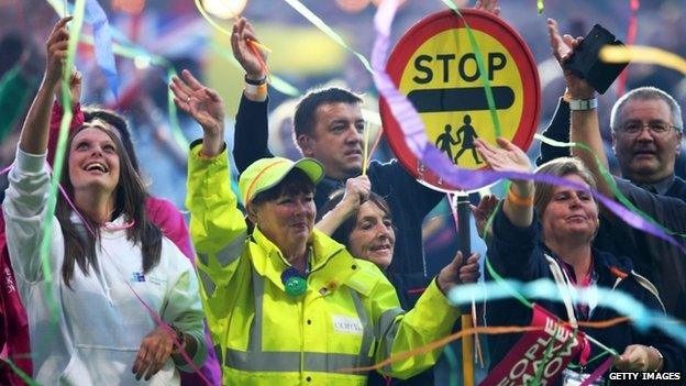 city workers enter the stadium during the Glasgow 2014 Closing Ceremony