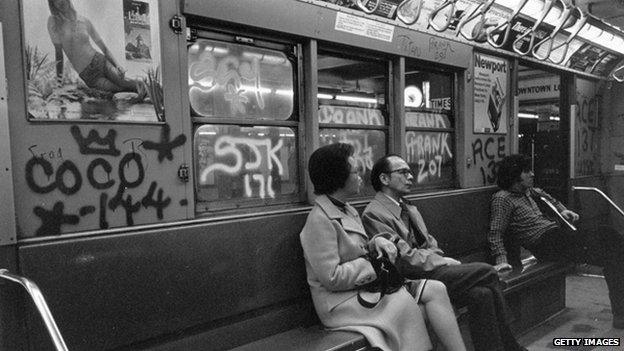 People in a graffiti-covered carriage in New York in 1972