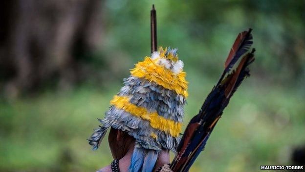 A Munduruku in feather headdress in April 2014