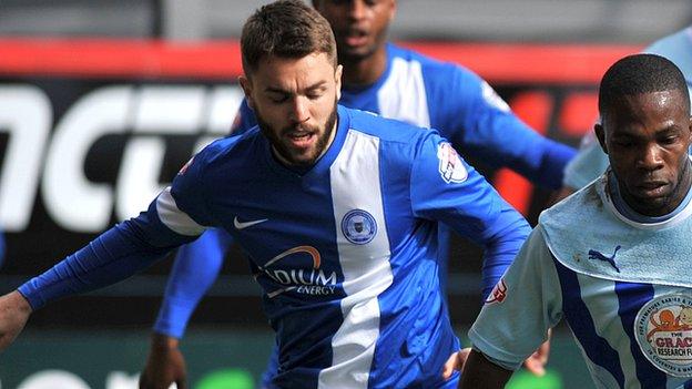 Josh McQuoid challenges Coventry striker Callum Wilson during the Sky Blues' trip to Peterborough in April