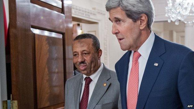 US Secretary of State John Kerry (R) walks with the Prime Minister of Libya Abdullah al-Thinni following their private bilateral meeting at the US Department of State 4 August 2014