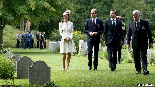 The Duke and Duchess of Cambridge walk through St Symphorien Military Cemetery, in Mons, with David Cameron.