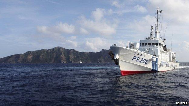 Japan Coast Guard vessel PS206 Houou sails in front of Uotsuri island, one of the disputed islands, called Senkaku in Japan and Diaoyu in China, in the East China Sea, in this 18 August 2013 file photo