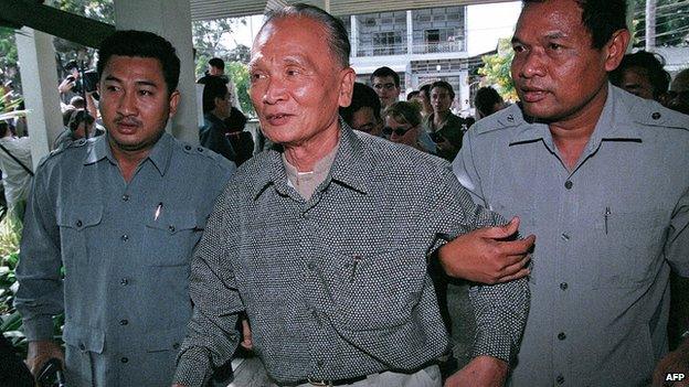 This photo dated 29 December 1998 shows Nuon Chea being helped by bodyguards on his arrival at a hotel in Phnom Penh