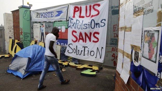 A migrant goes inside in a squat opened by activists from the No Borders UK network in a former recycling factory in Calais August