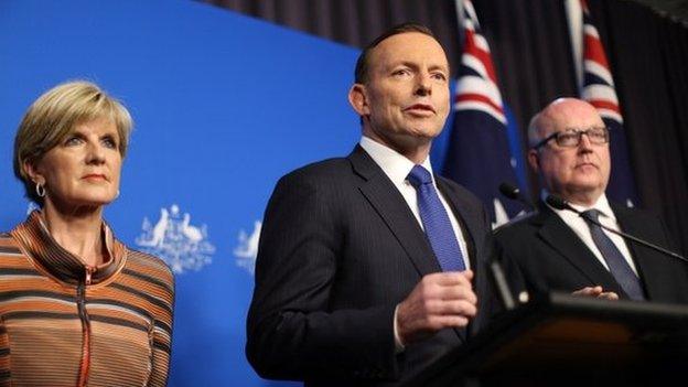 This picture released by the Australia Prime Minister Office on 5 August 2014 shows Prime Minister Tony Abbott (centre) speaks at a joint press conference with foreign minister Julie Bishop and Attorney General George Brandis (right) in Canberra