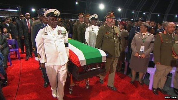 The coffin of Nelson Mandela is carried by military honour guard