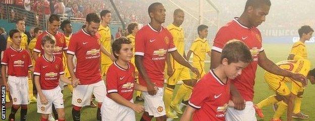 Manchester United and Liverpool walk onto the pitch ahead of their International Champions Cup final