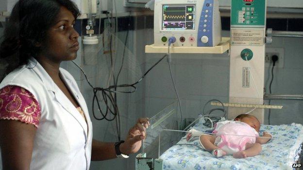 File photo: An Indian nurse attends to Japanese baby Manji Yamada as she lies in a ward of The Arya Hospital in Jaipur, India, 6 August 2008