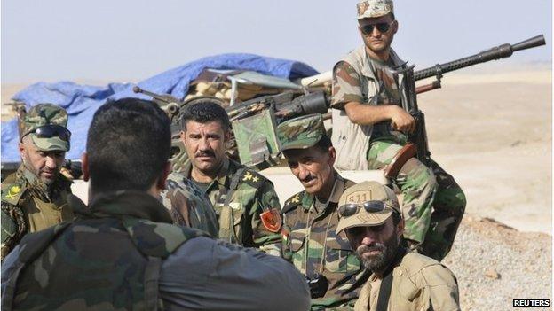 Peshmerga forces stand guard on the outskirts of Sinjar, west of Mosul on 5 August 2014.