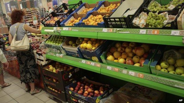 People buy imported fruit at a supermarket in downtown Moscow