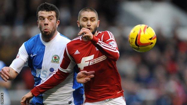 Nottingham Forest's Henri Lansbury (right) battles for possession with Grant Hanley of Blackburn Rovers