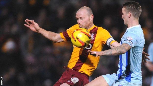 Gary Jones (left) and Coventry City's Carl Baker (right) battle for possession