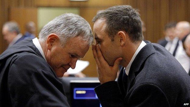 Oscar Pistorius speaks to his main defence lawyer, Barry Roux - 4 March 2014