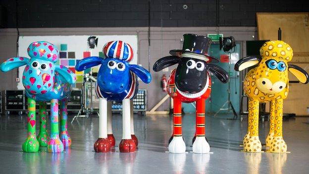 Four customised Shaun sculptures