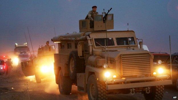 Kurdish Peshmerga fighters on their military vehicles drive towards the front lines of Mosul villages where they are fighting against the soldiers from the Islamic State