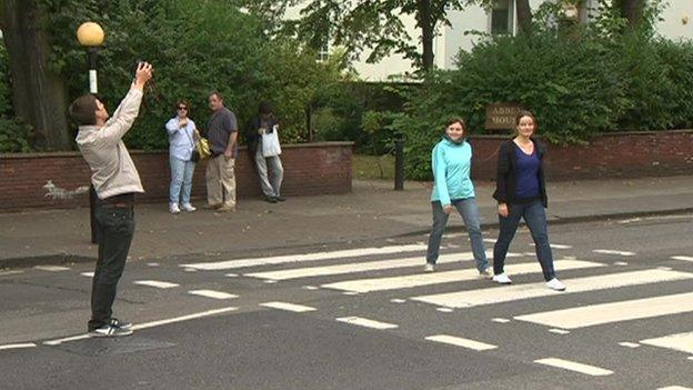 People taking photos on the Abbey Road crossing